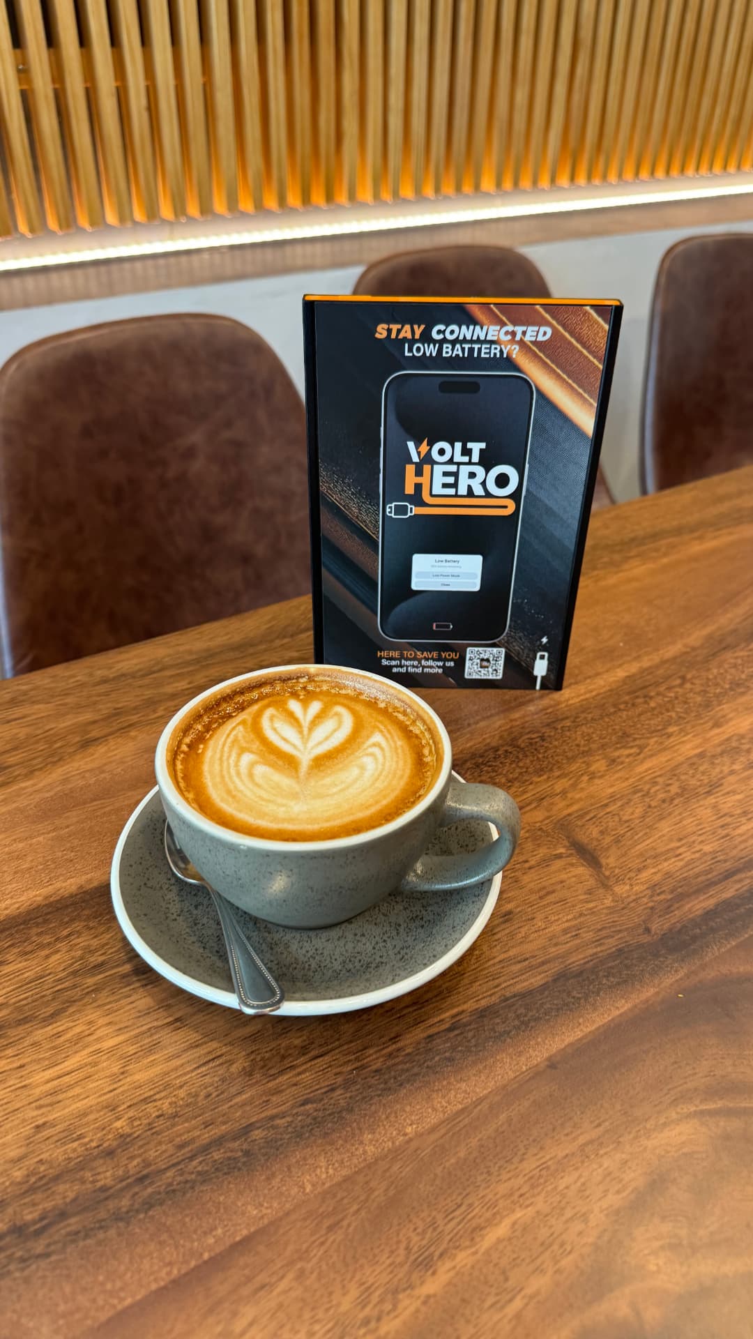 VOLT HERO station on a cafe table next to a cappuccino
